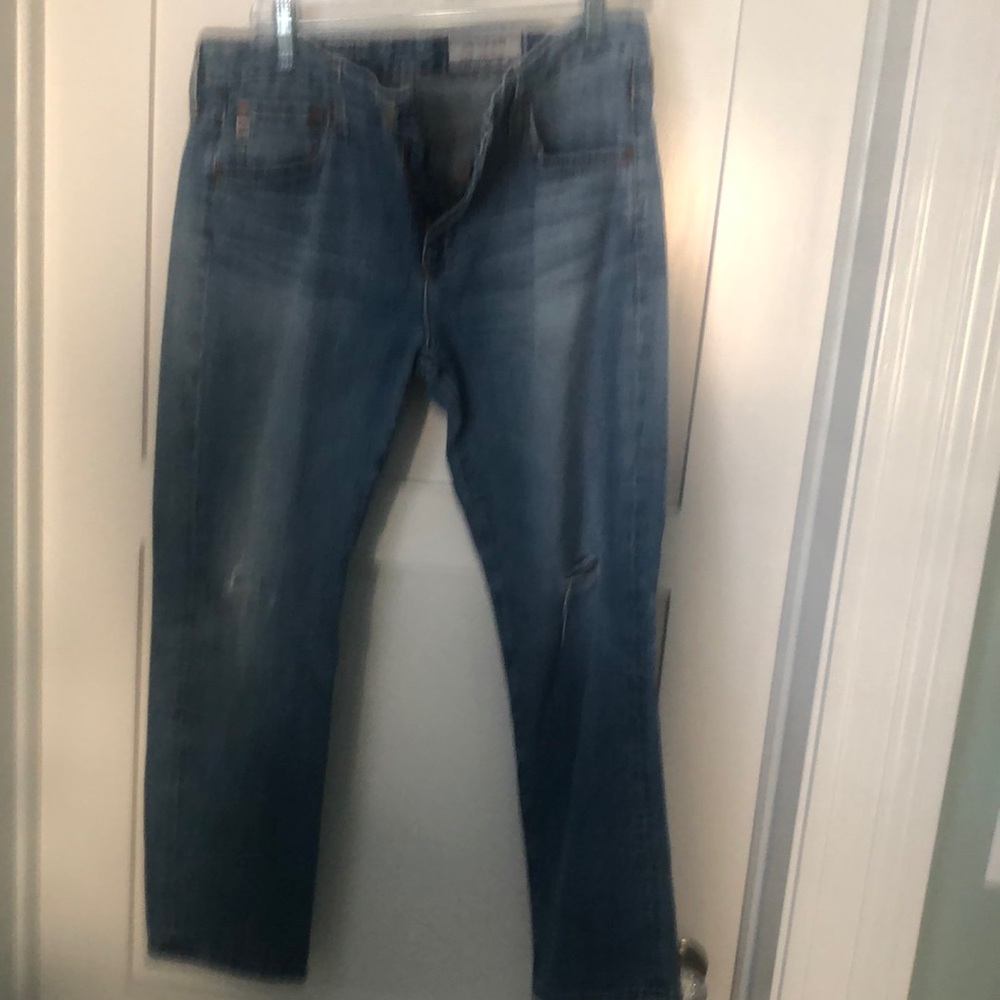 AG jeans with knee rips.